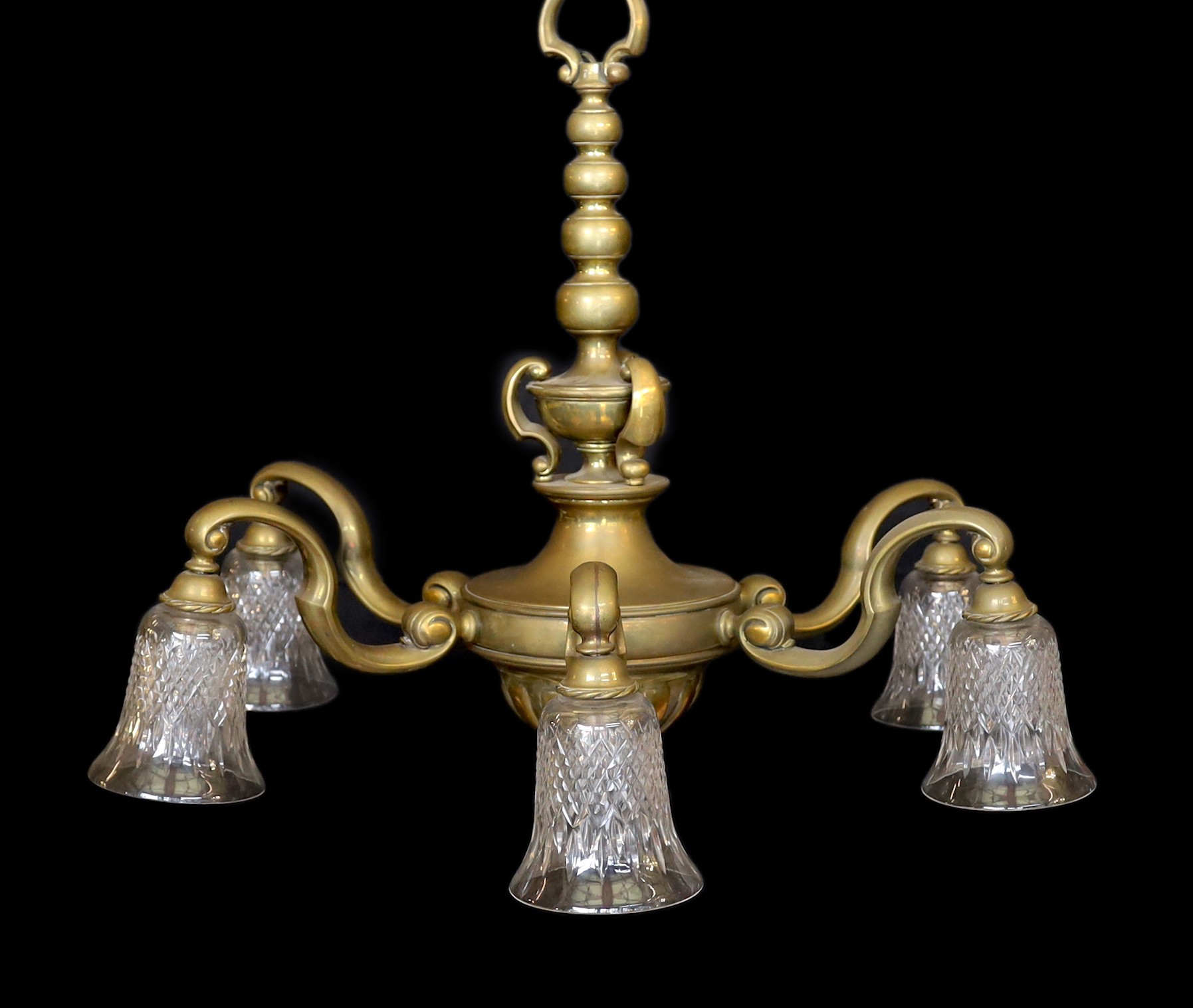 An early 20th century English bronze six light chandelier with cut glass shades, drop 70cm. width 80cm